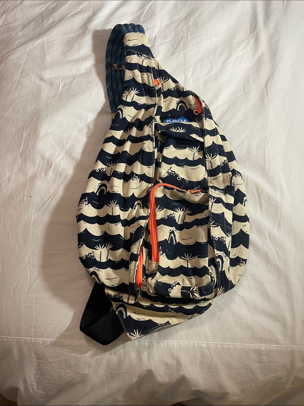 Kavu Wave-Print Sling Bag in Navy, Cream & Orange Accents